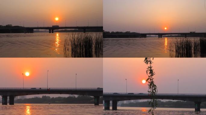 河边夕阳太阳照在水面上水天一色大桥剪影