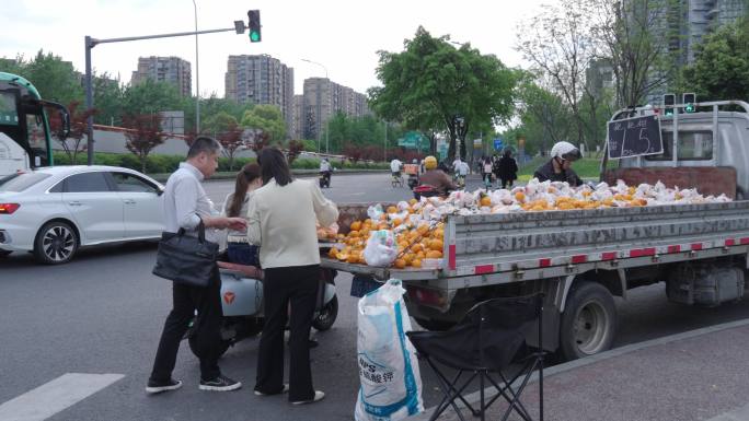 城市中行人过马路，路人走过，旁边有摆摊