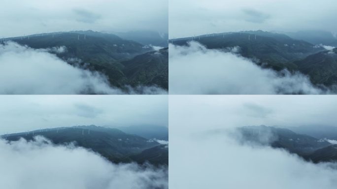 春天云雾缭绕中高山上的风力发电风车