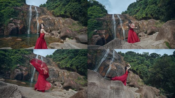 红衣女子在山间瀑布前跳舞