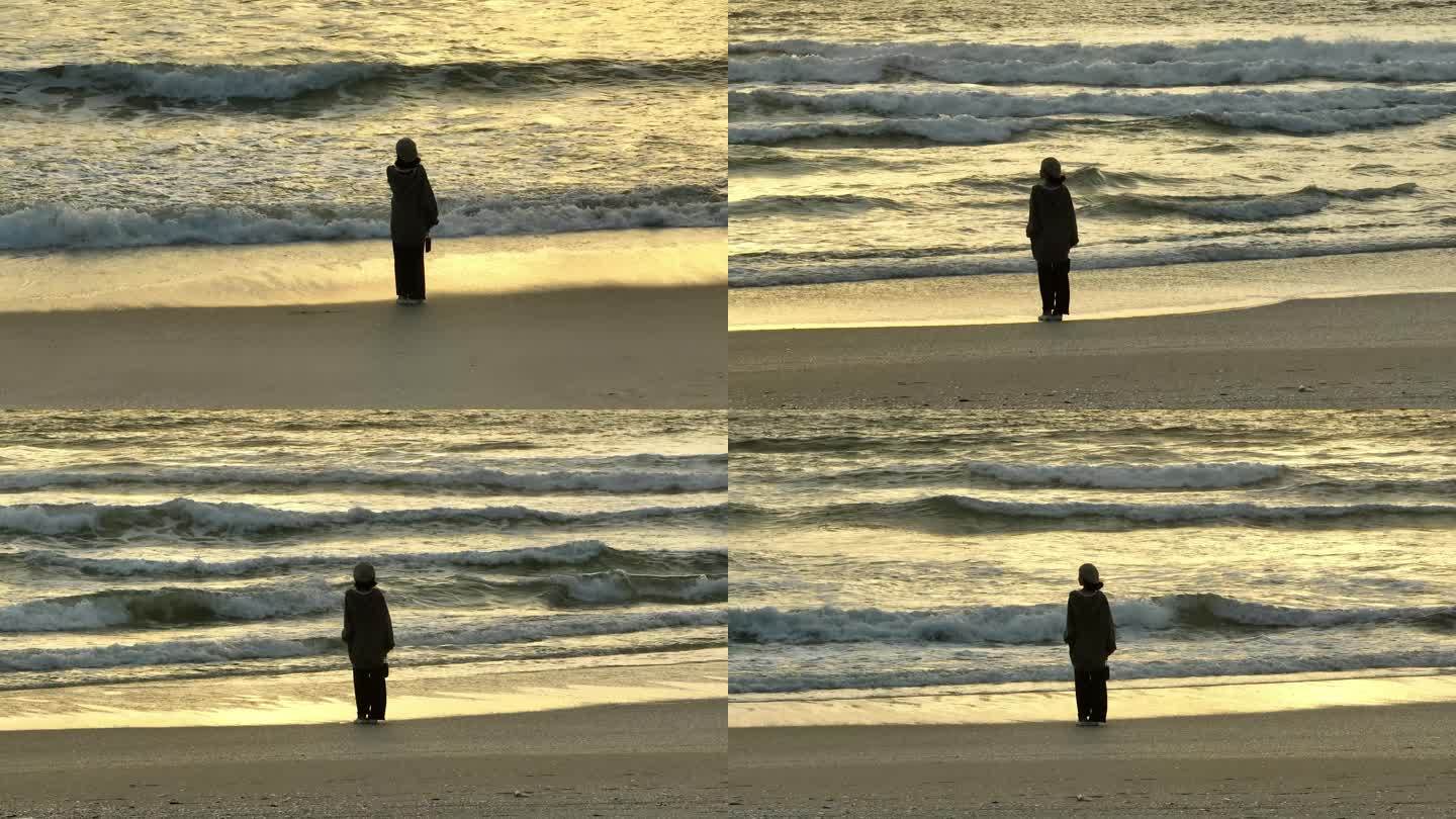 女孩在海边散步日落日出