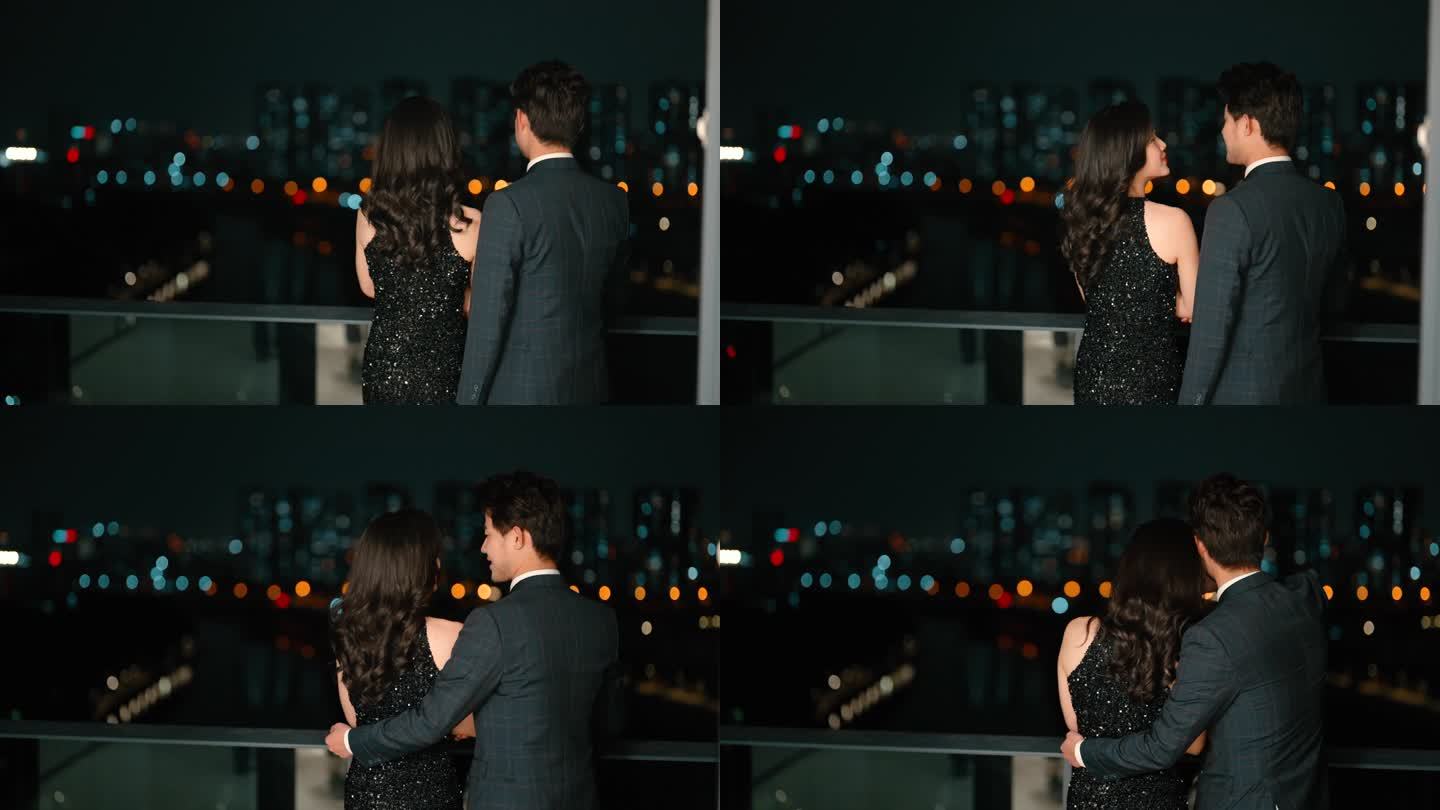 夫妻一起看江景夜景城市夜景阳台