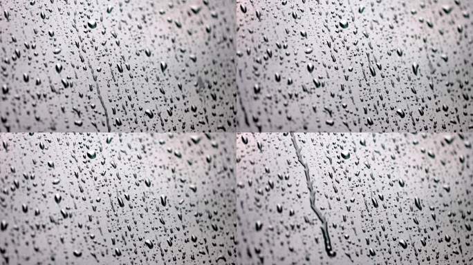 （慢镜）下雨天雨水水滴从玻璃上滑落