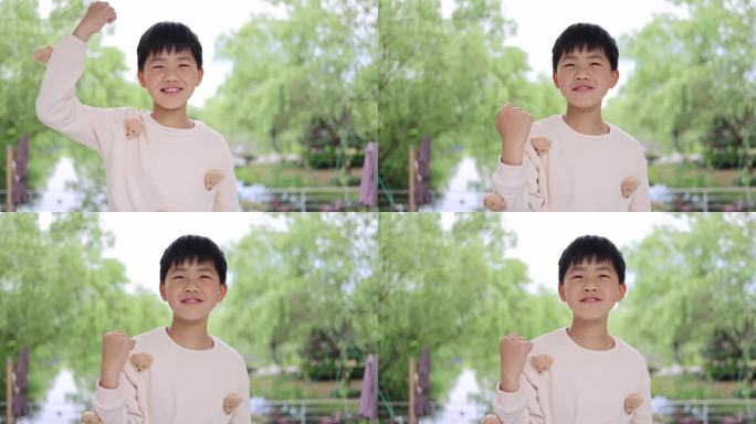 可爱的中国小男孩做手势加油打气唯美慢镜