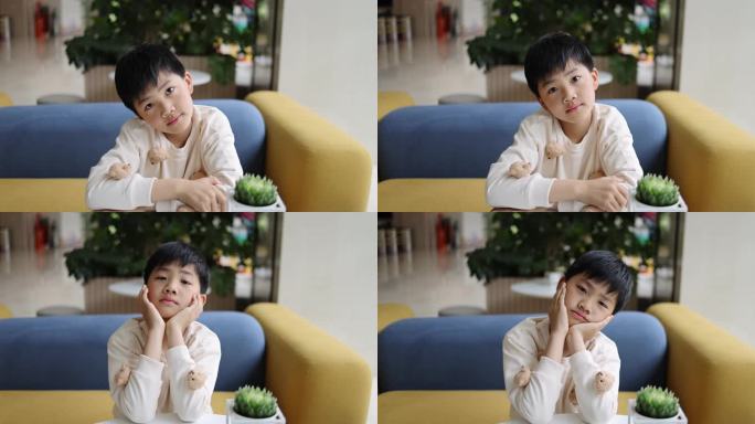 可爱的中国小男孩坐在沙发上