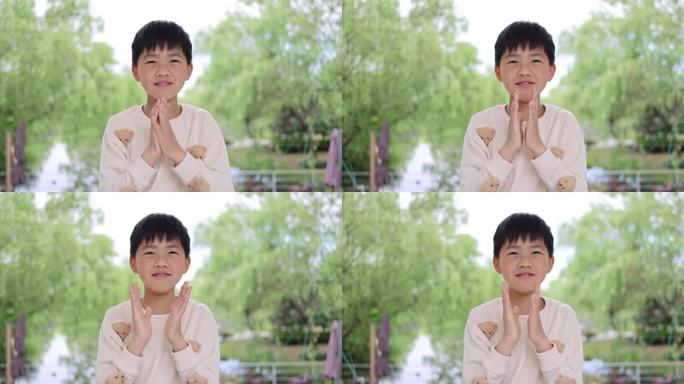 可爱的中国小男孩做手势鼓掌唯美慢镜
