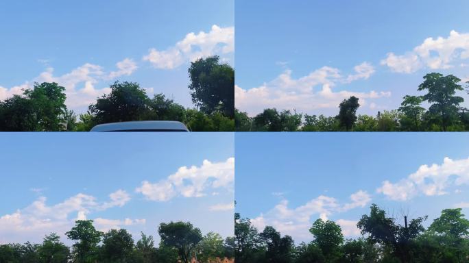 车窗外风景蓝天白云绿树景色