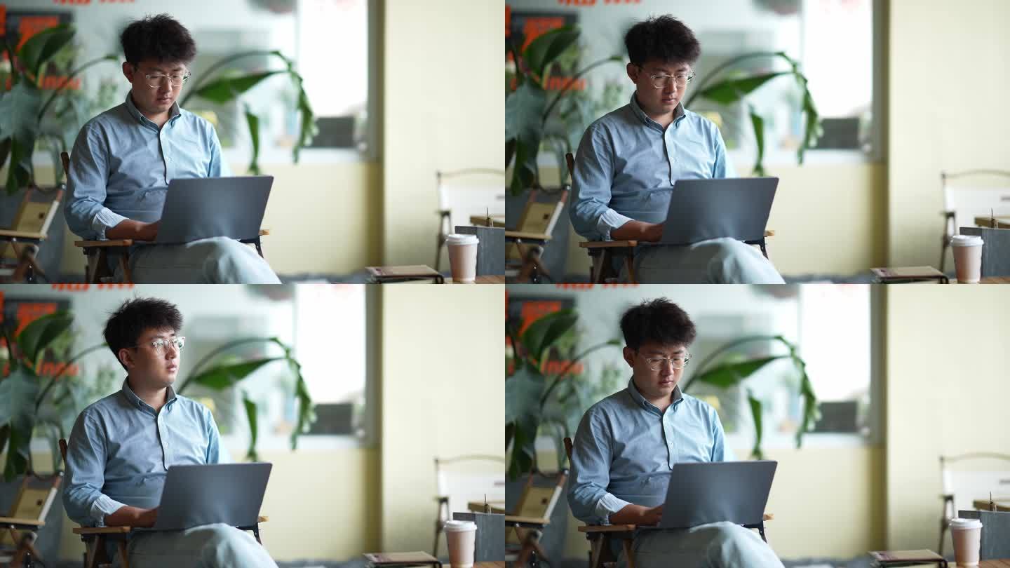 年轻男人在咖啡店使用笔记本电脑工作