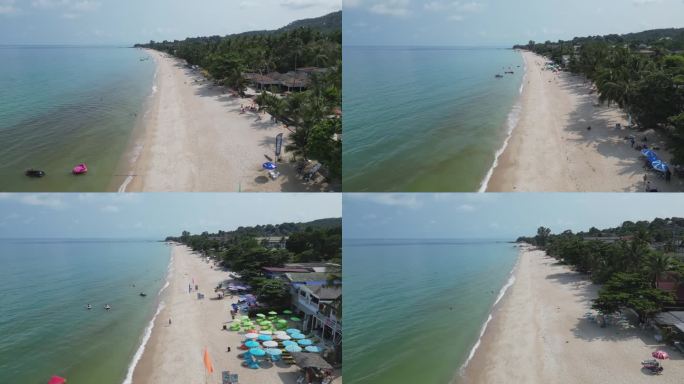 夏天海边白色沙滩游客游玩度假日光浴