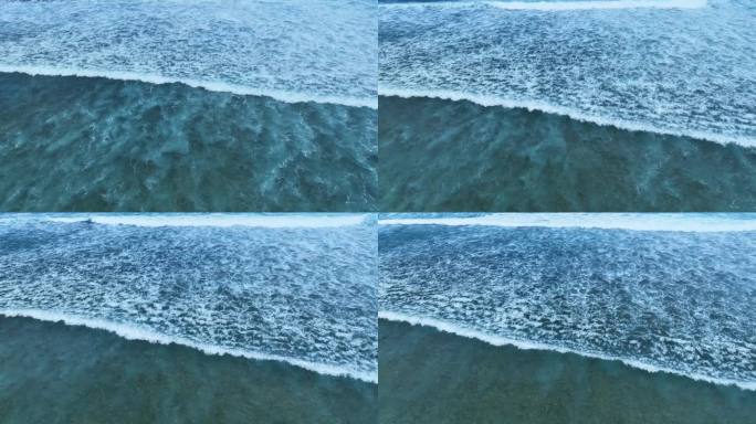 清澈透明的蓝色海水与白色波浪