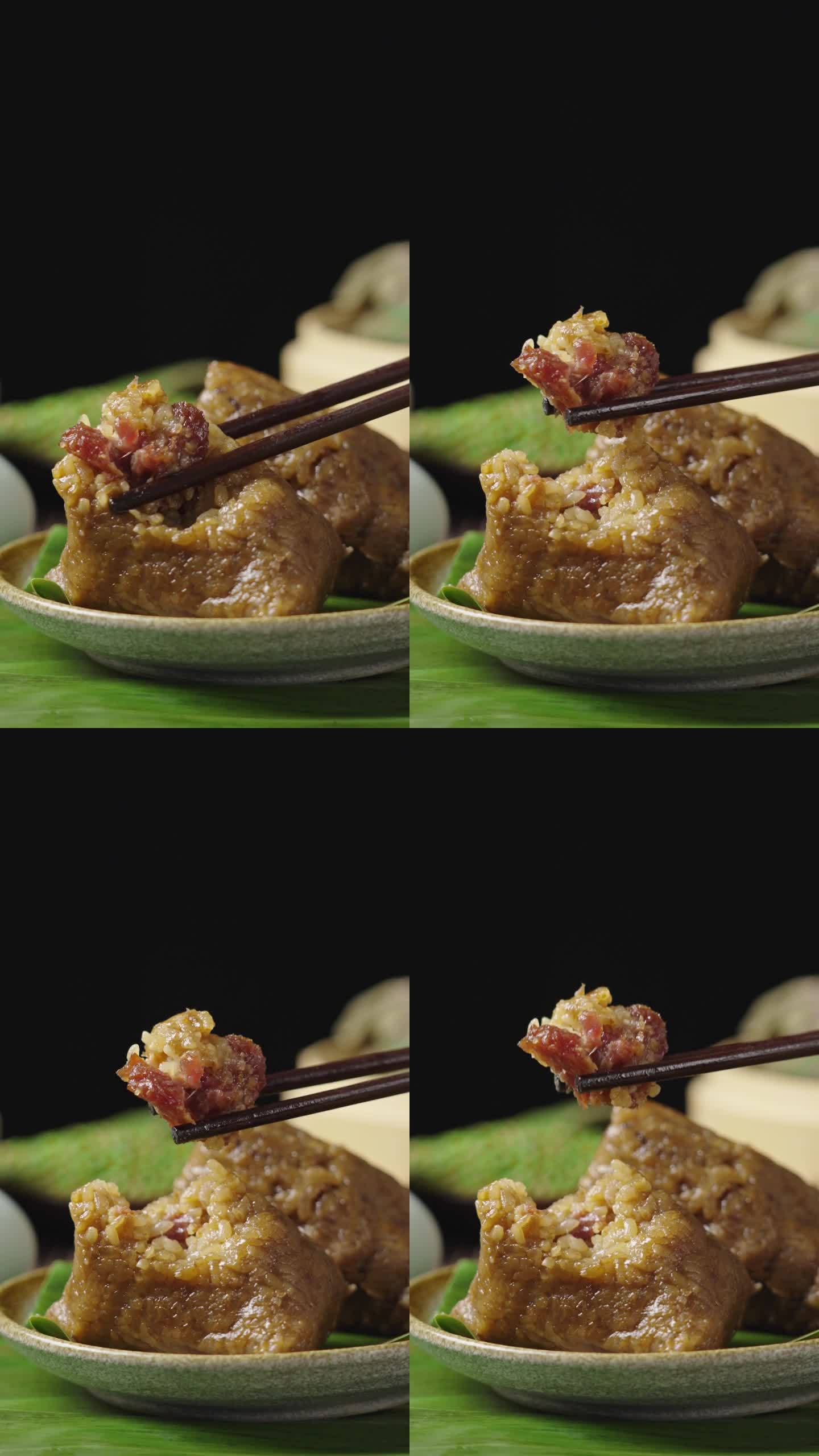 筷子夹起的大肉粽端午节吃粽子