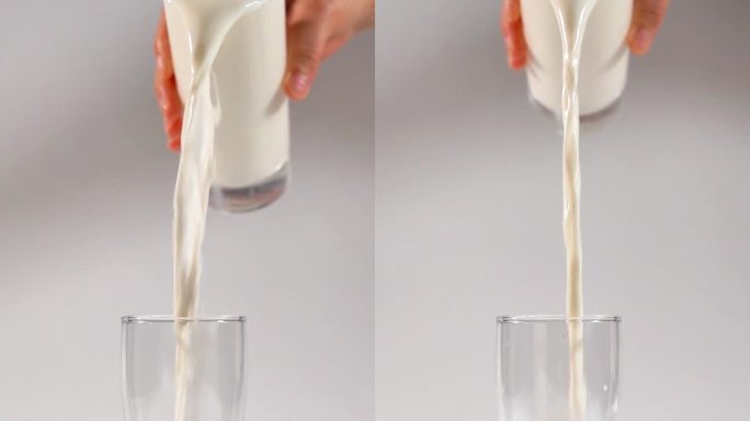 新鲜纯牛奶倒出流动的广告
