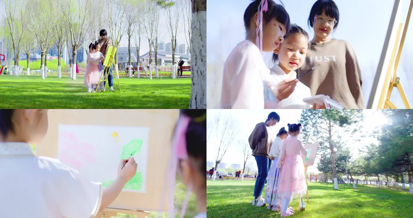 家长陪孩子在公园草坪画画6K