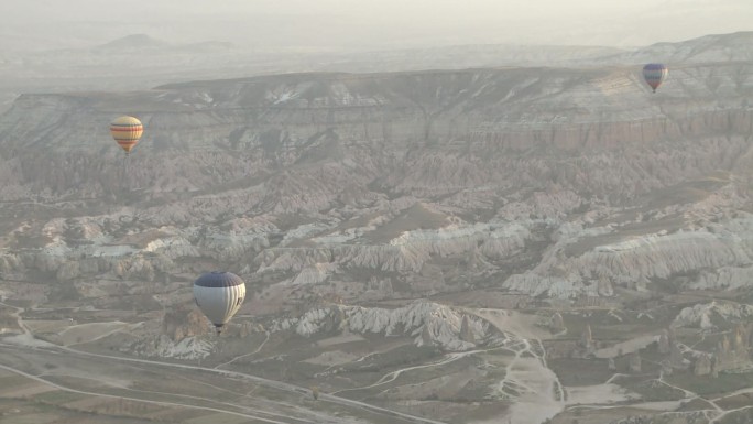 气球飞过土耳其卡帕多西亚的岩石山谷