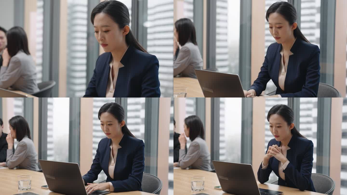 年轻商务女子在会议室使用笔记本电脑