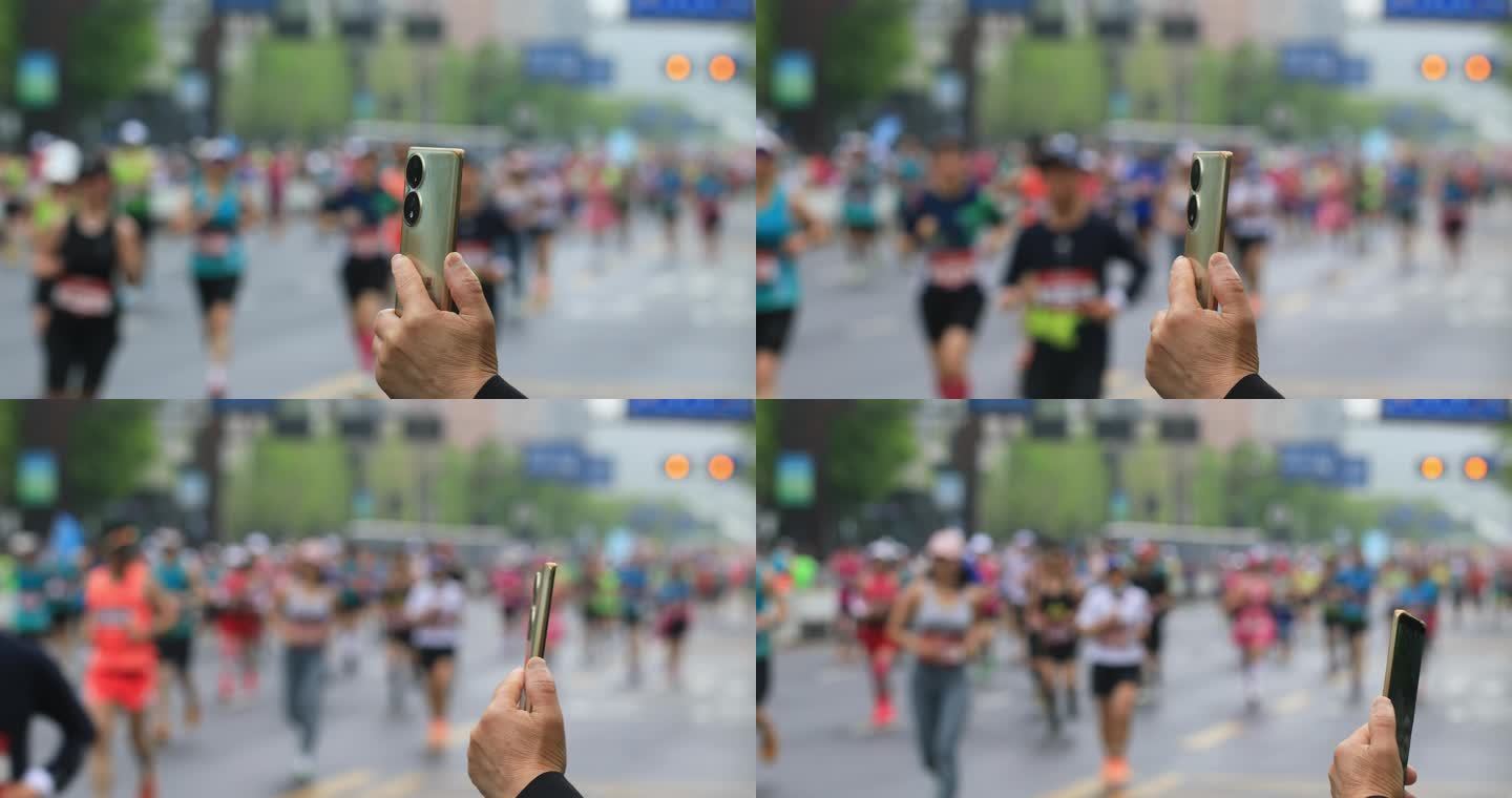 用手机拍摄正在进行的马拉松比赛