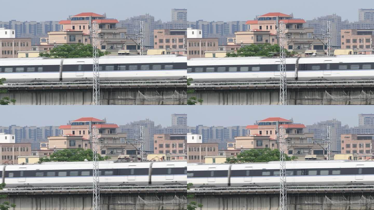 和谐号高速列车快速驶过城市高架桥