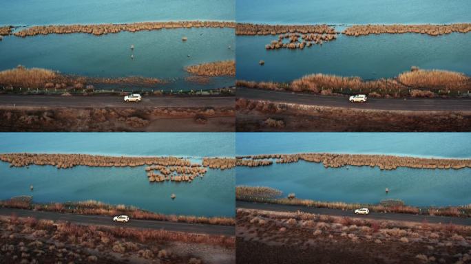 航拍4K新疆甘肃青海湖荒漠湖边行驶的汽车