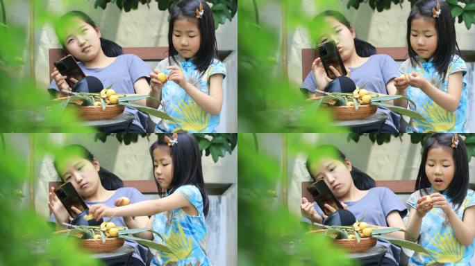 姐姐妹妹在院子里看手机吃枇杷