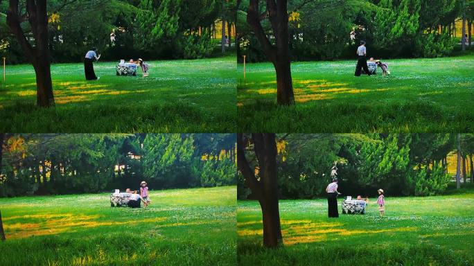 公园草坪上妈妈给小女孩拍照片/亲子游玩