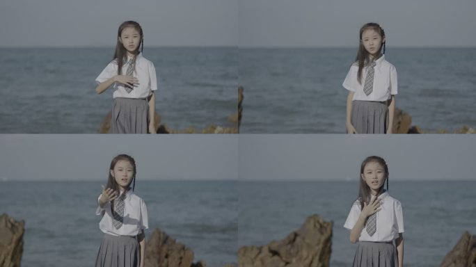 穿着校服的女中学生女孩站在海边录制素材