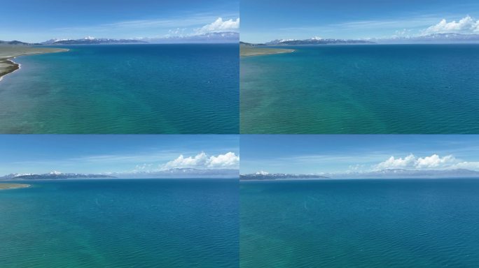 航拍晴天新疆赛里木湖清澈的蓝绿色渐变湖水