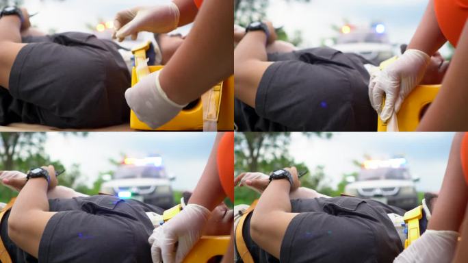 救护小组抢救一名车祸受害者的受伤人员