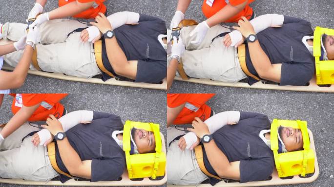 救护小组抢救一名车祸受害者的受伤人员