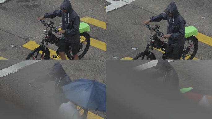 雨中推自行车的人