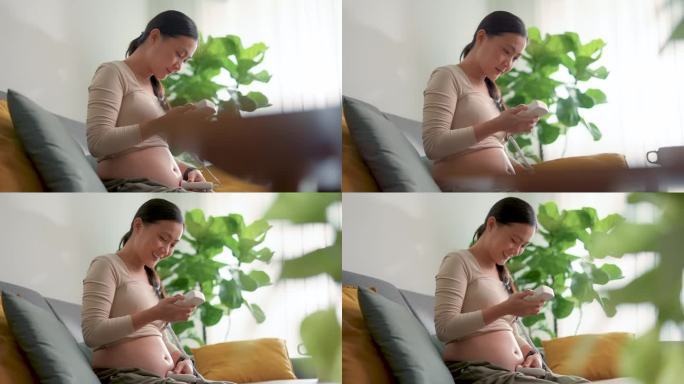 亚洲孕妇用袖珍多普勒聆听婴儿的心跳，露出快乐的微笑。