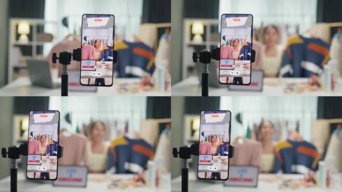 特写手机屏幕记录亚洲女士视频博主看手机相机评论毛衣新系列直播在IG网上销售故事卷抖音在家工作室工作。