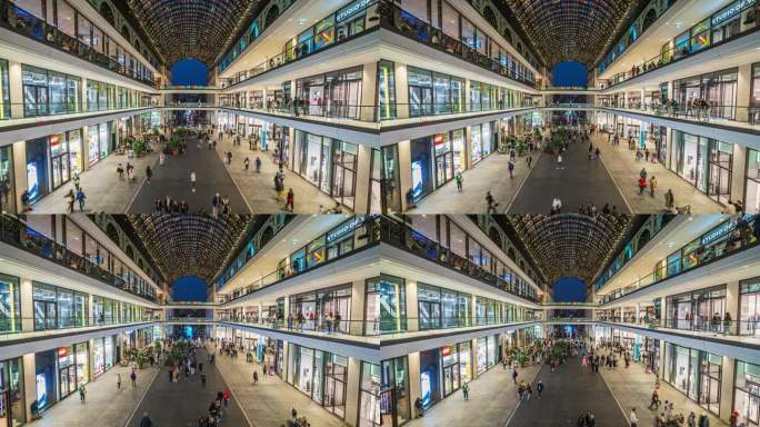 在德国，欧洲柏林市中心的现代购物商场里，顾客和游客在百货商店里逛来逛去