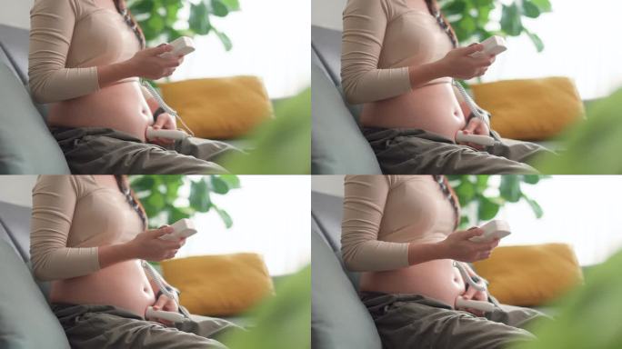 孕妇用袖珍多普勒聆听婴儿心跳的特写镜头。