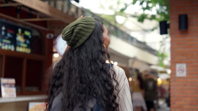 一个年轻的女人在她的假期里走在街市上。