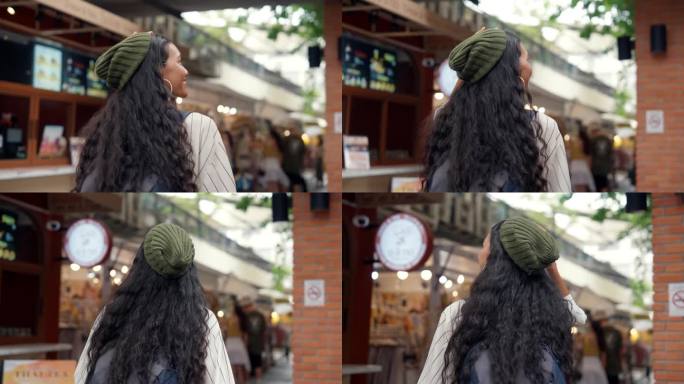 一个年轻的女人在她的假期里走在街市上。