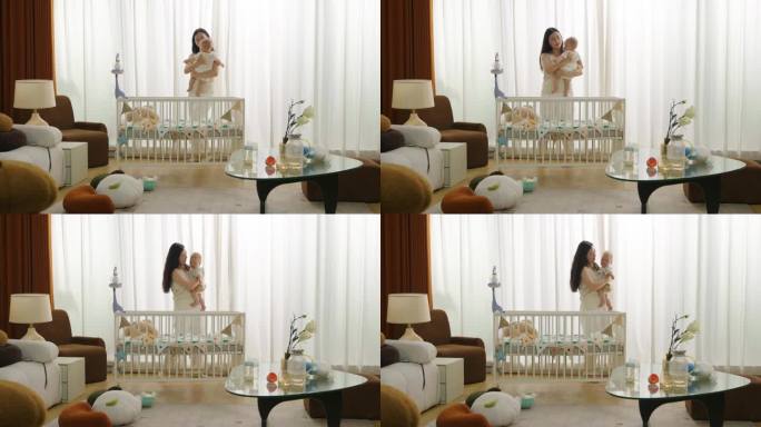母亲抱婴儿哄孩子睡觉婴儿床
