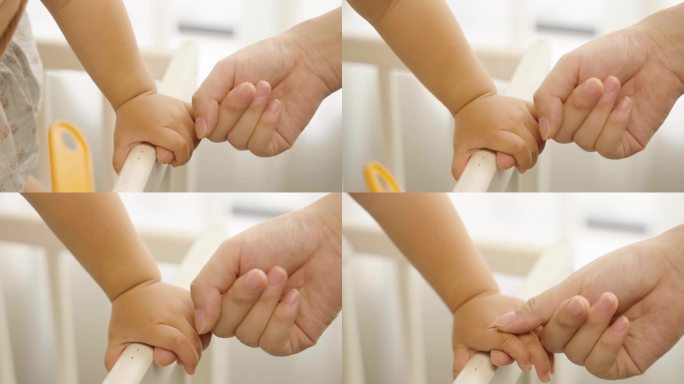 婴儿母亲大手拉小手牵手母爱新生生命