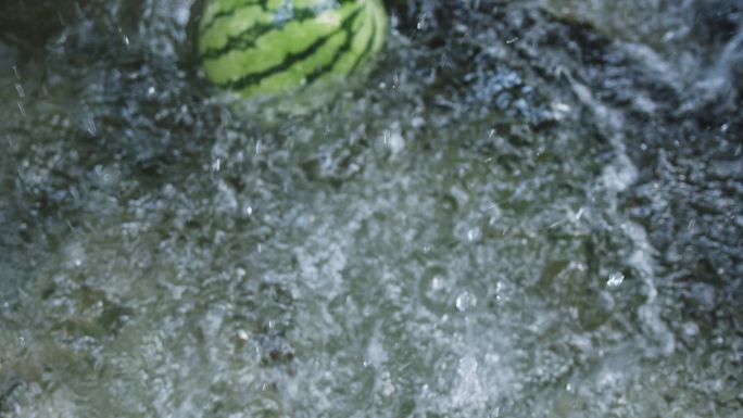 清凉夏日西瓜水果掉进溪水里