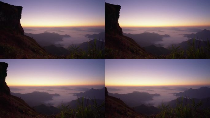 日出时在山上欣赏大自然美景的田园风光。高山和山脊被云雾包围着进入清晨。