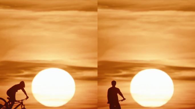 超级慢动作时间扭曲效果剪影山地自行车骑下坡对雄伟的太阳在晴朗的天空在日落。极端的运动员。