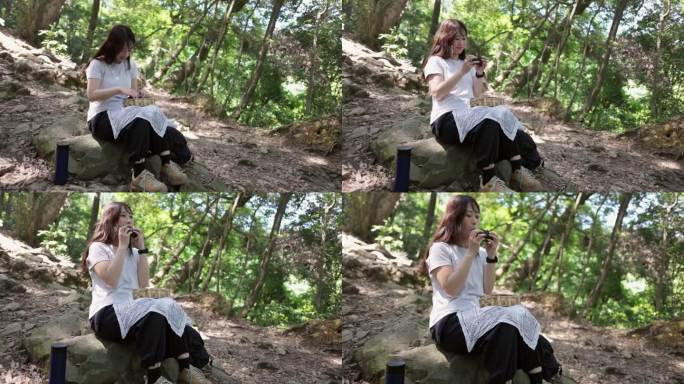 女徒步者坐在山间小道上吃午饭(三集之二)