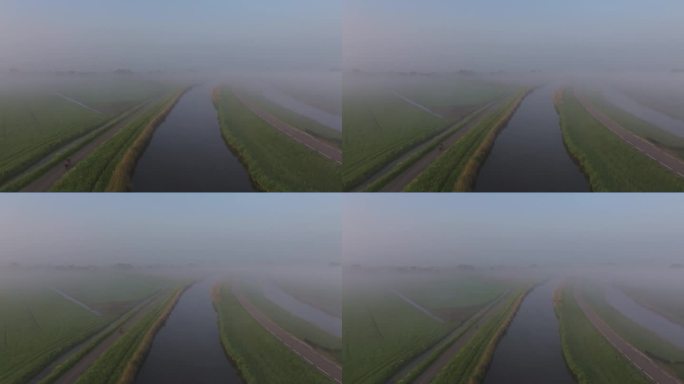 荷兰，雾蒙蒙的河流和绿色田野的鸟瞰图。