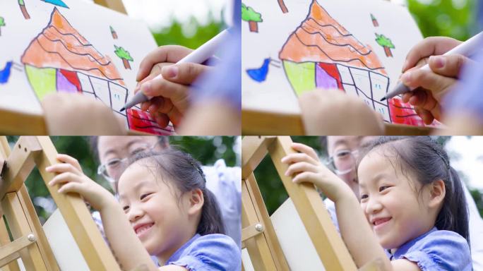 幼儿园孩子拿画笔绘画大手拉小手温馨开心