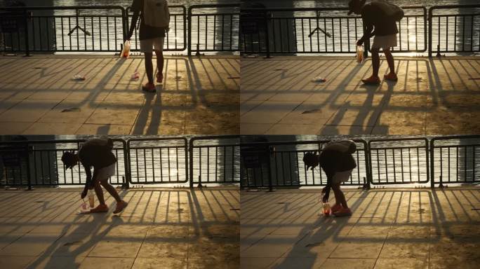 一个年轻人捡起地上垃圾