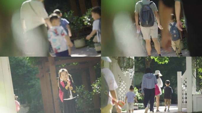 幼儿园放学家长接孩子出校门小女孩奔跑回头