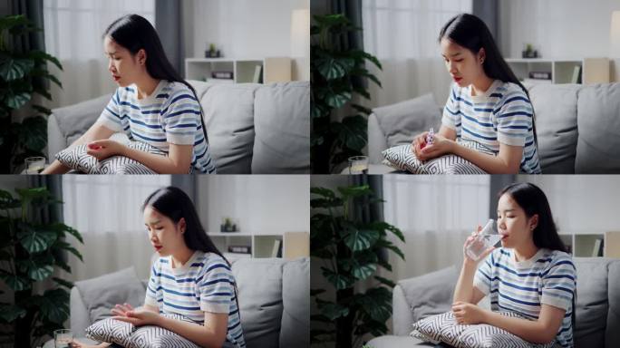 年轻的亚洲女子正在家里舒适的沙发上服药。