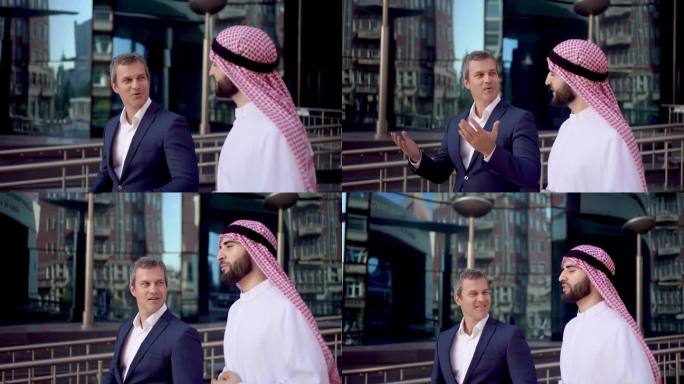 两个阿拉伯人、高加索人商人开会洽谈发展事宜。穆斯林商业伙伴洽谈项目投资城市城市户外。沙特、阿联酋、阿