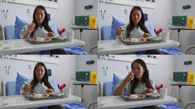 孕妇坐在医院病床上吃饭