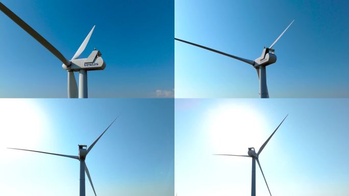 天空湛蓝的维斯塔斯风力涡轮机的航拍轨道照片