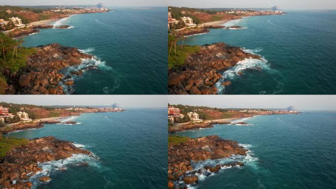 鸟瞰碧绿的海浪撞击岩石海岸线，大海在布满巨石的海岸线周围编织。Kovalam海滩，印度喀拉拉邦。